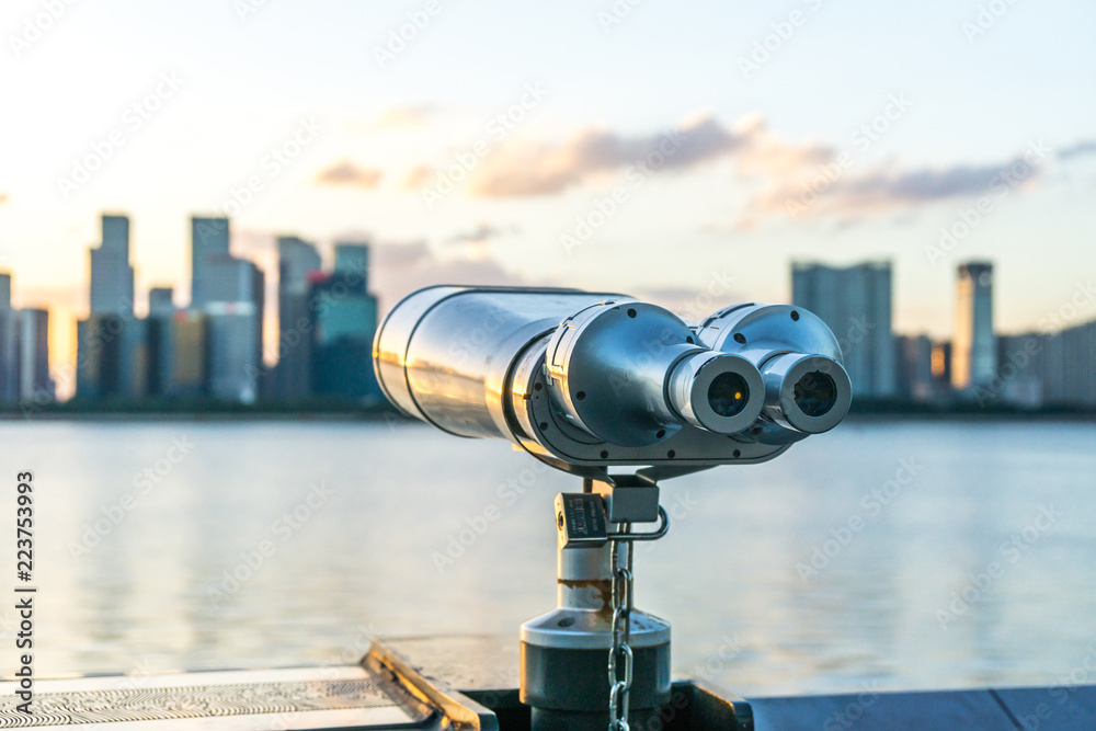 telescope with city skyline