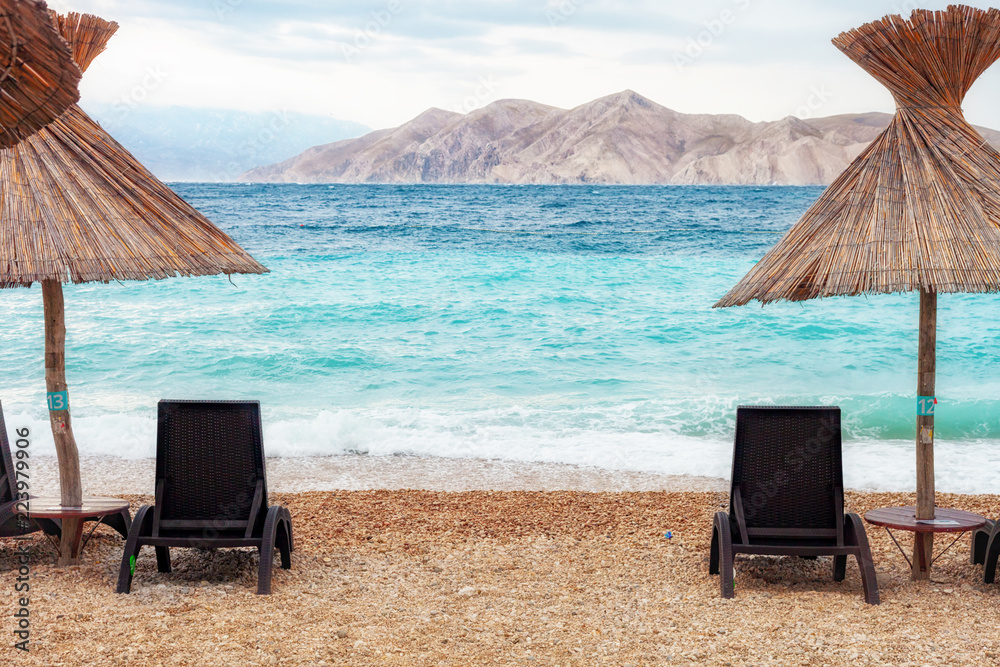 Empty sunbeds on beach before or after tourist season