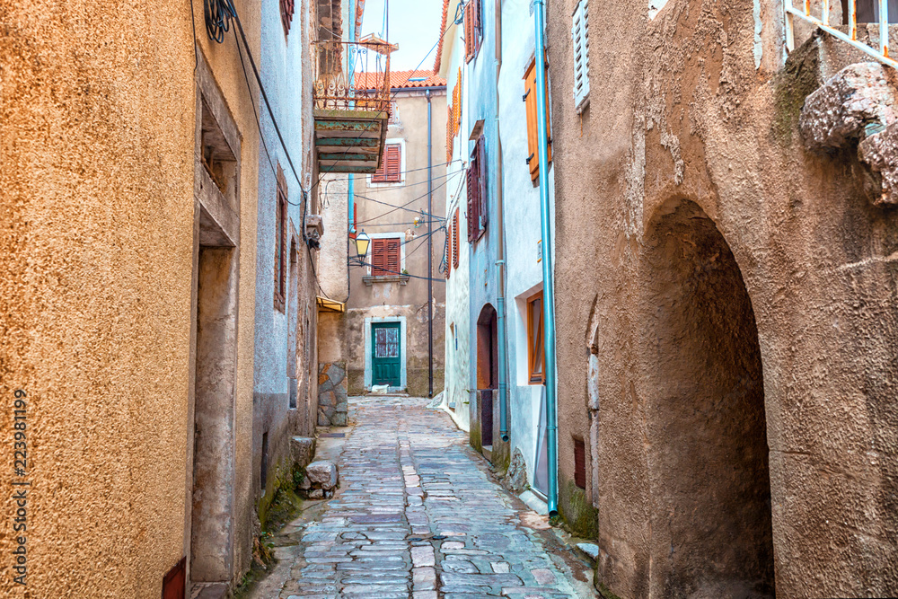 Narrow street with stones houses in Croatia, Vrbnik on Krk Island