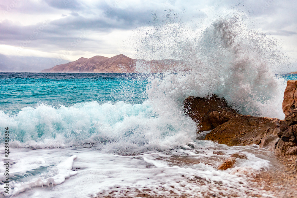 Storm on the tropical sea, crashing waves on rocks