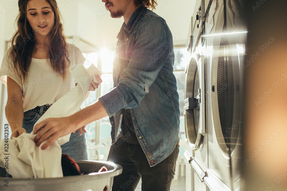 Couple looking at the clothes after wash