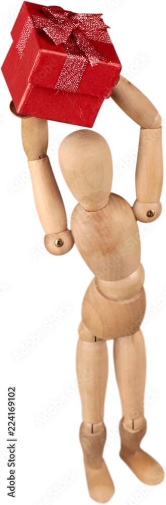 Miniature wooden mannequin holding a gift