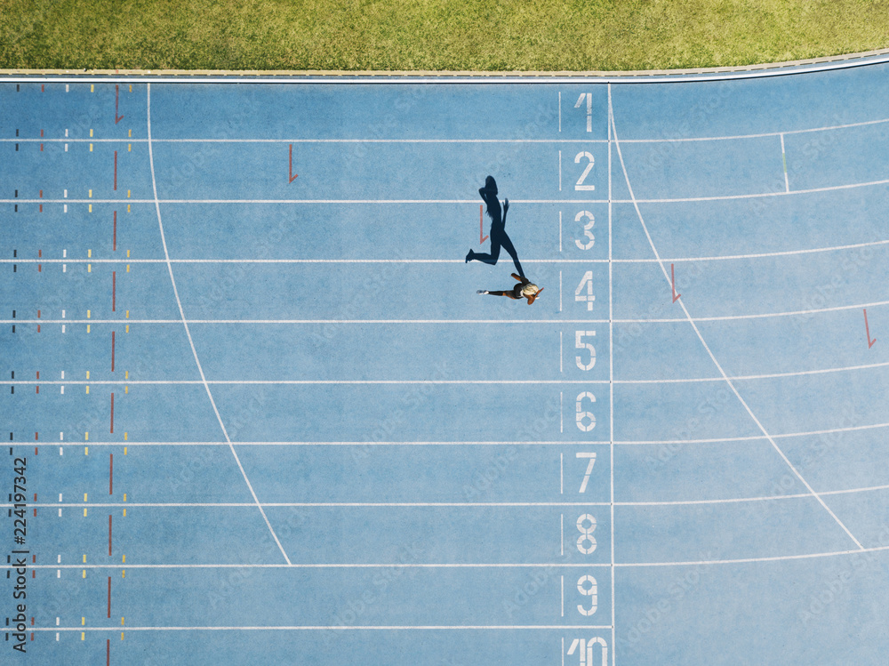 Track and field track with sprinter in overhead shot