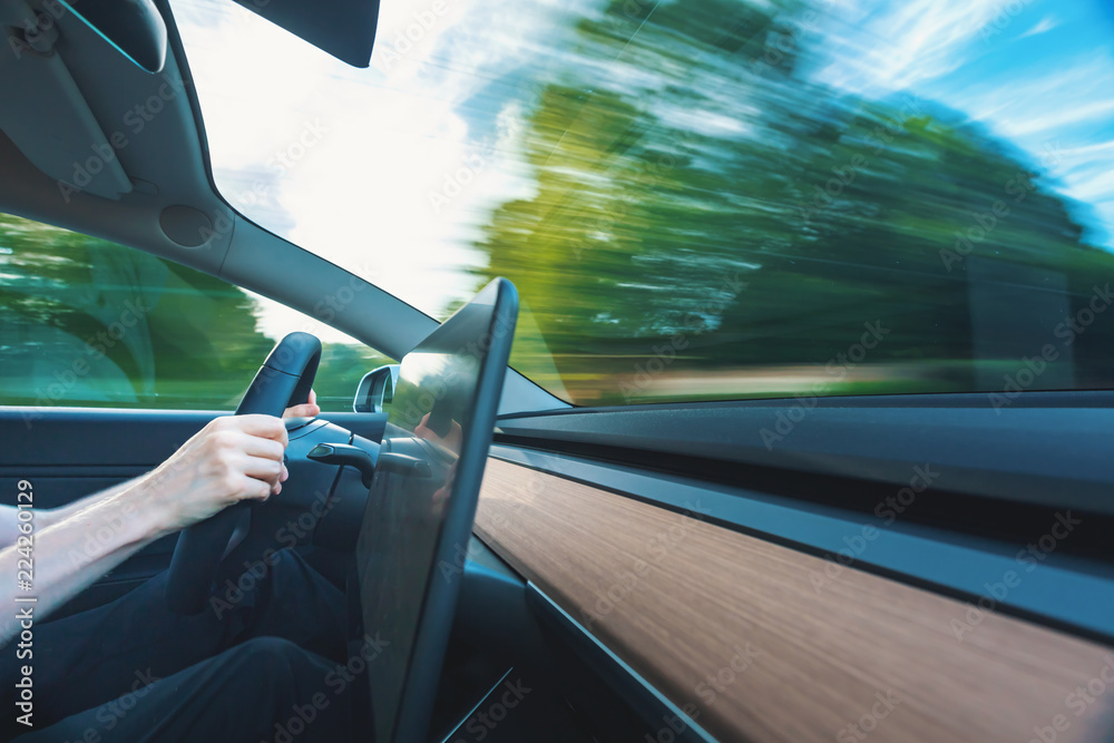 Luxury vehicle driving down the road with motion blur