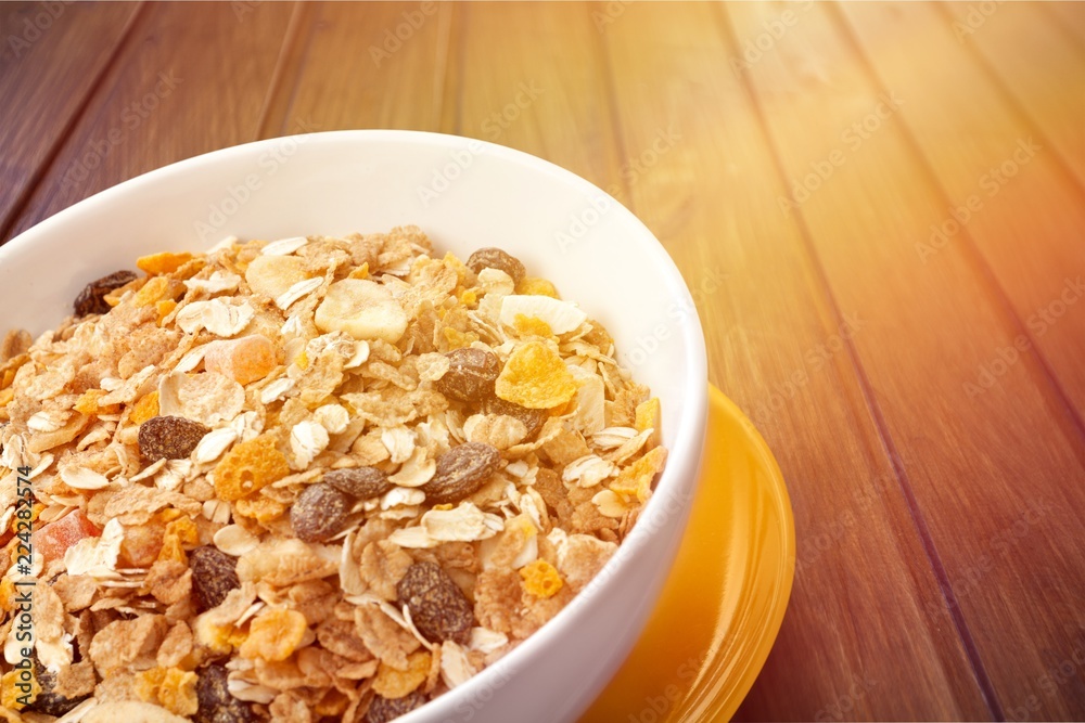 Bowl of  tasty corn flakes  on background