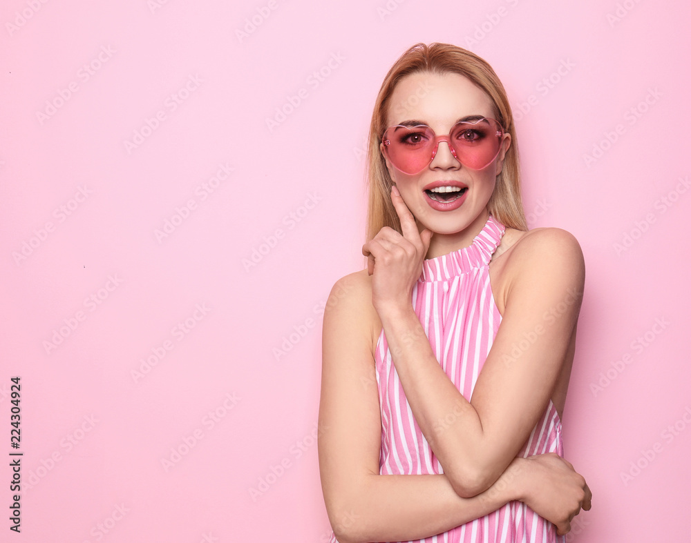 Portrait of beautiful young woman on color background