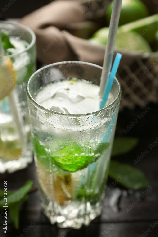 Glass of fresh mojito on wooden table