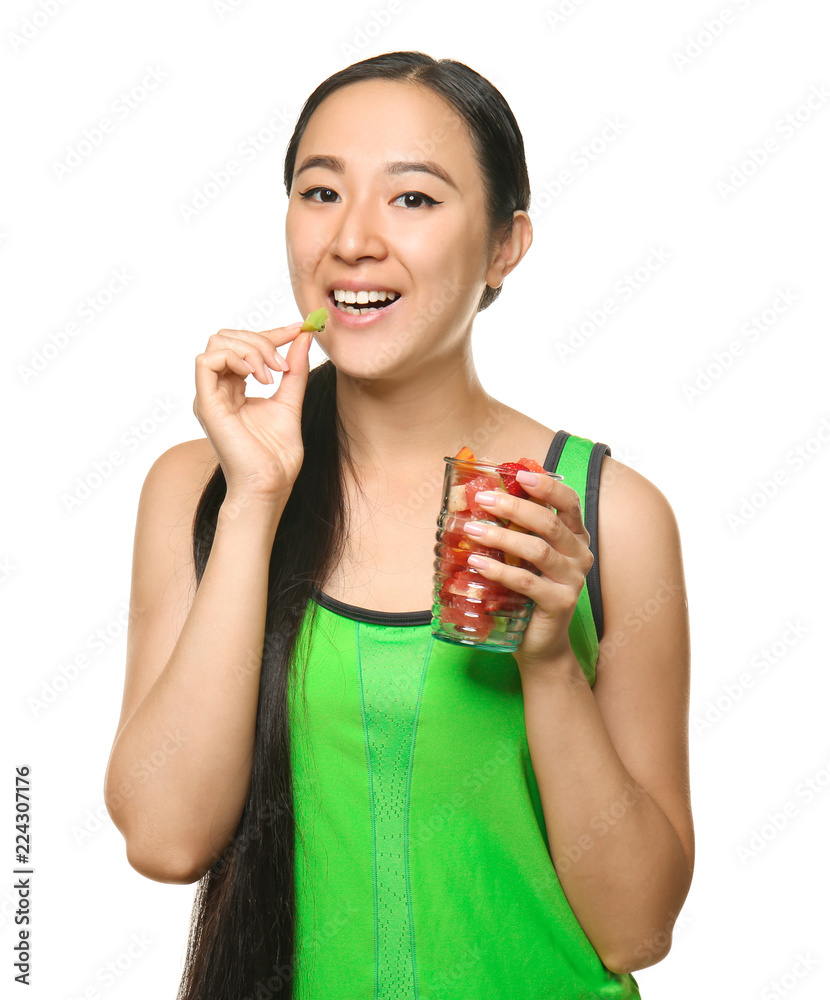 Asian woman with healthy fruit salad on white background