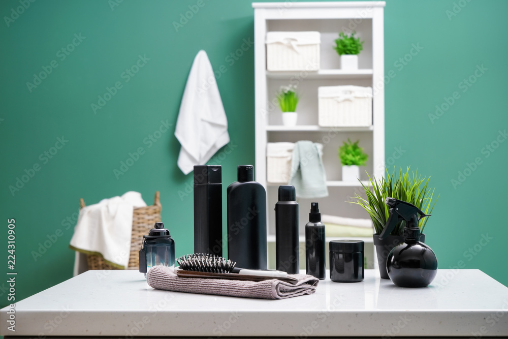 Set of cosmetics and accessories on table in bathroom