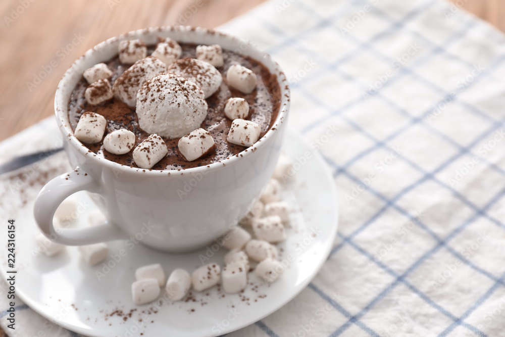 Cup of hot chocolate with marshmallows on table