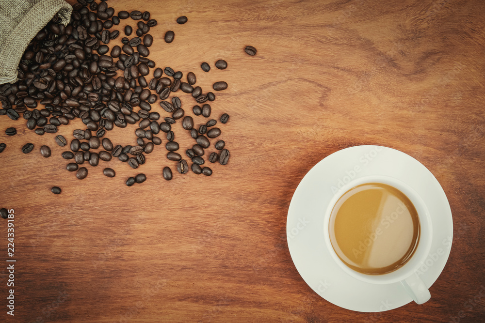 top view coffee cup and beans on wood background