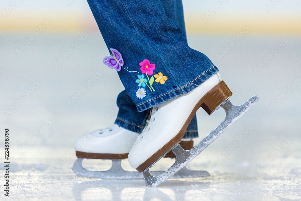 Close-up of Legs in Skates on Skating Rink