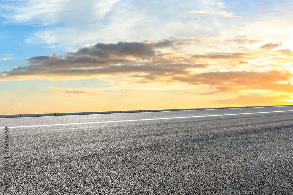 Clean asphalt highway and beautiful sky clouds at sunset