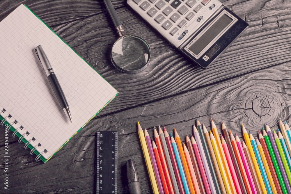 Pencils ,notebooks and phone on table