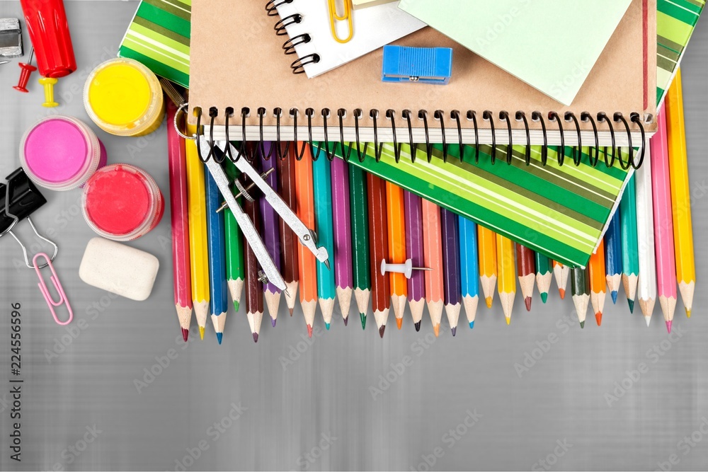 Colorful school supplies on wooden background