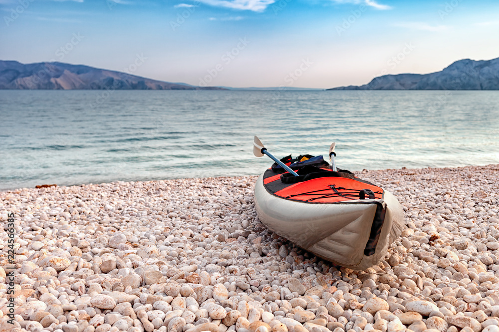 Empty kayak on beach over sea bay landscape, background with copyspace