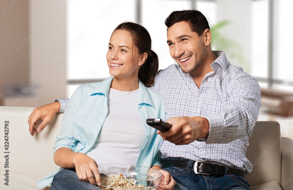 Young couple watching tv.