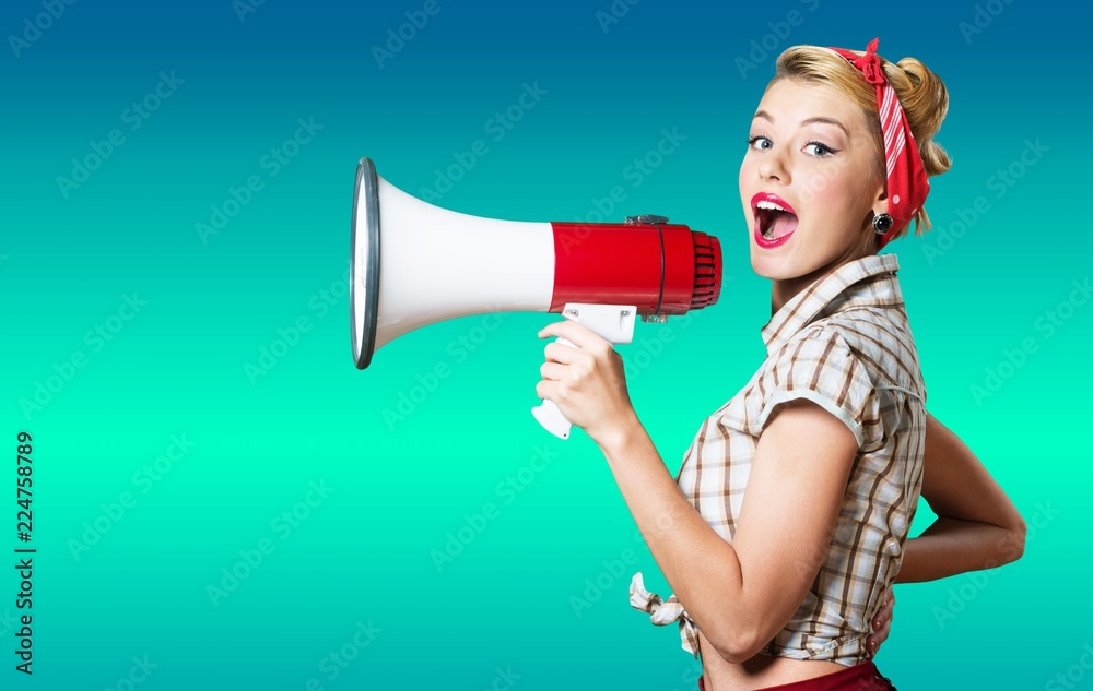 Portrait of woman holding megaphone, dressed in