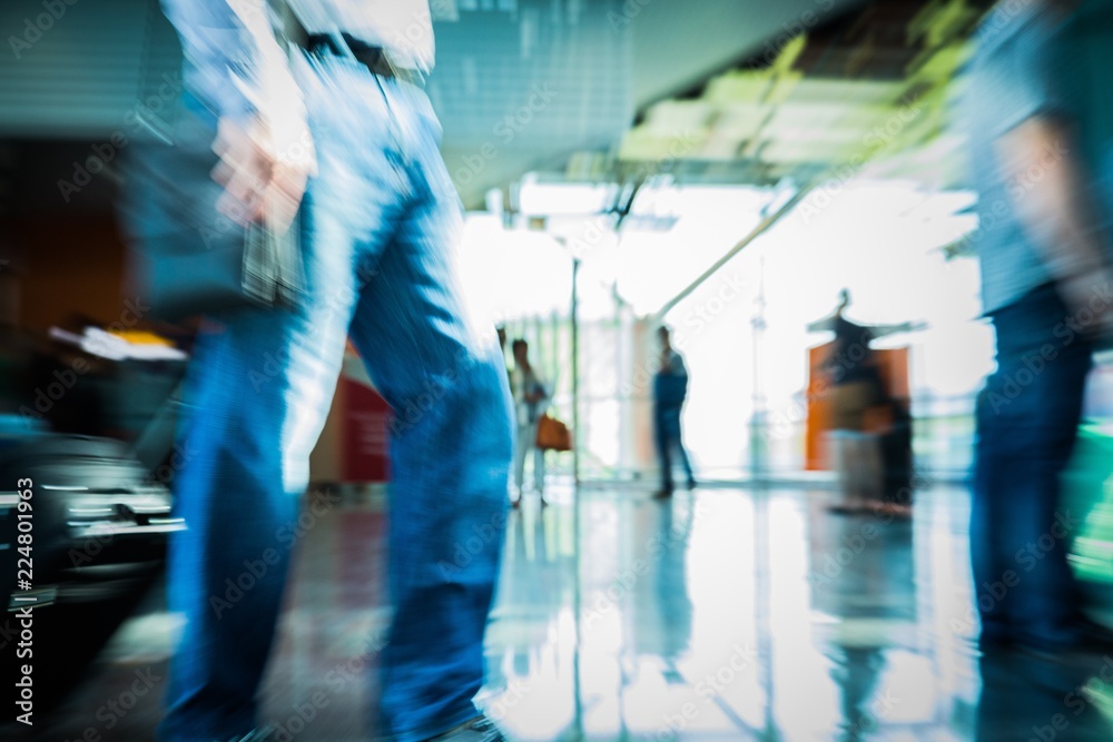 Closeup of People Walking in Airport Carrying Luggage