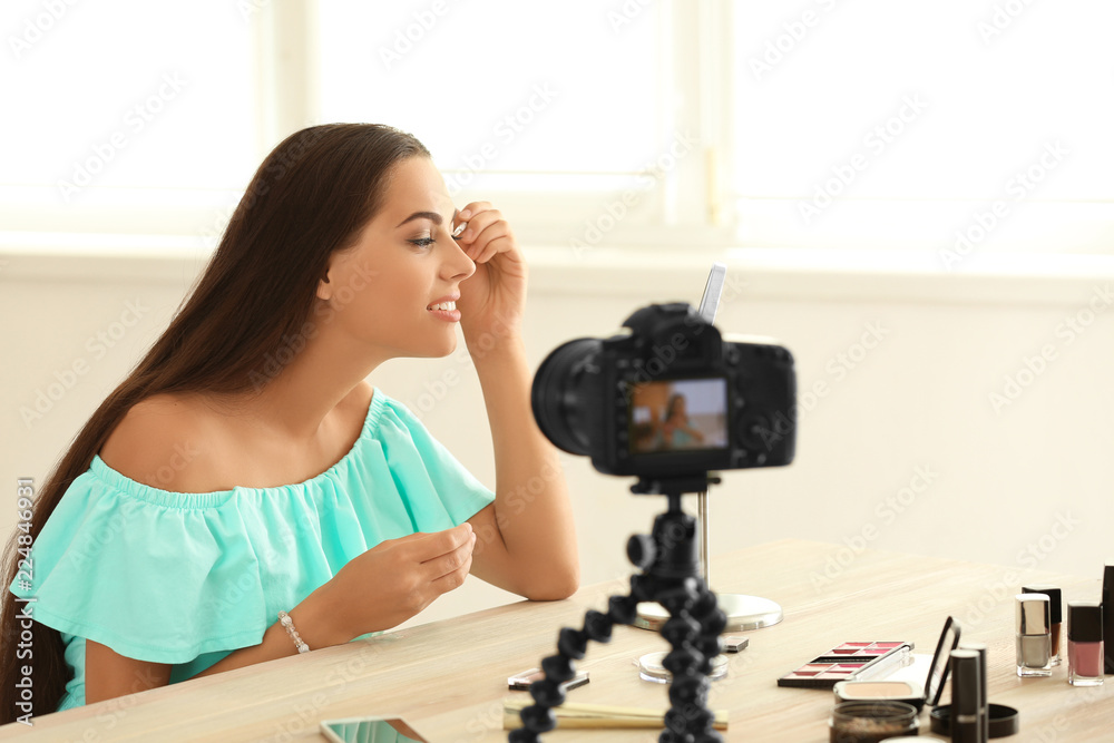 Young beauty blogger recording video at home