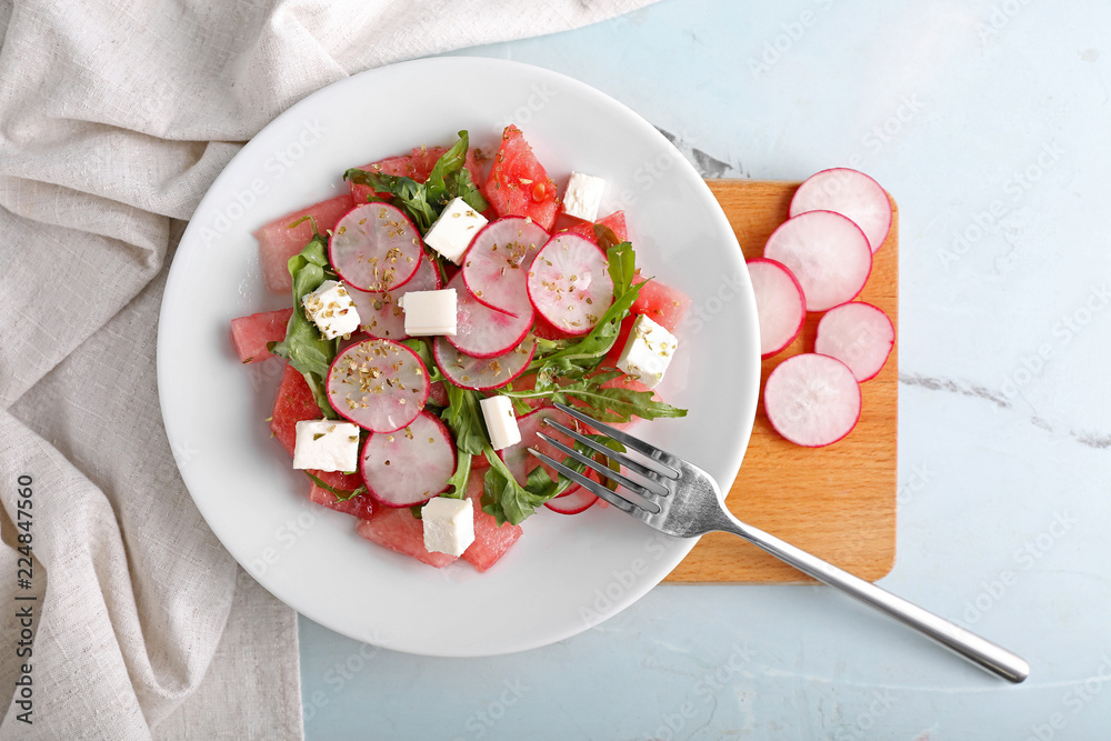 Plate with delicious watermelon salad on table