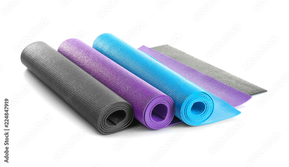 Different yoga mats on white background