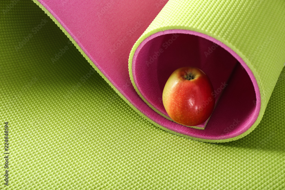 Yoga mat with fresh apple