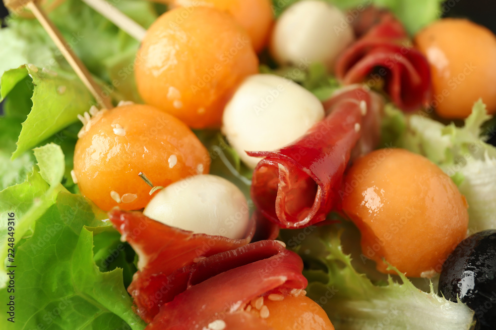 Skewers with melon, prosciutto and mozzarella, closeup