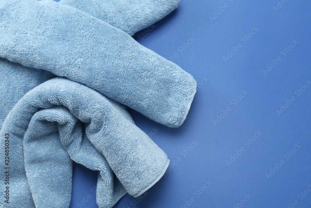 Clean soft towels on color background