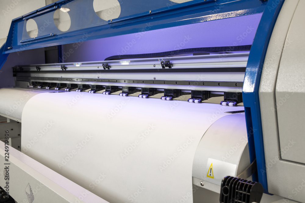 Blank paper roll in large printer format inkjet machine for industrial business.