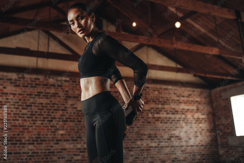 Woman relaxing her leg muscles at gym