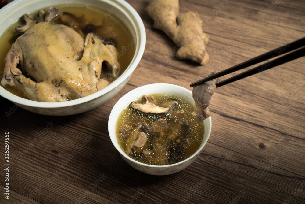 chicken soup with wooden background