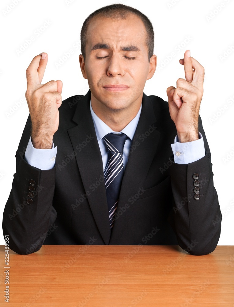 Portrait of a Businessman with Eyes Closed and Fingers Crossed