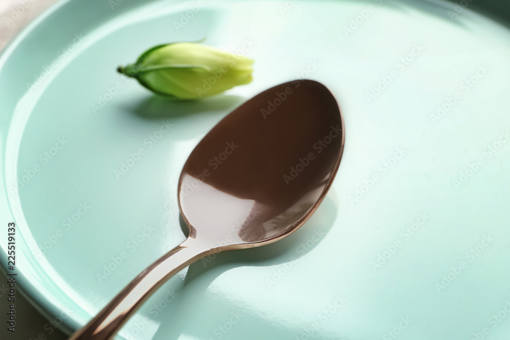 Spoon on plate, closeup