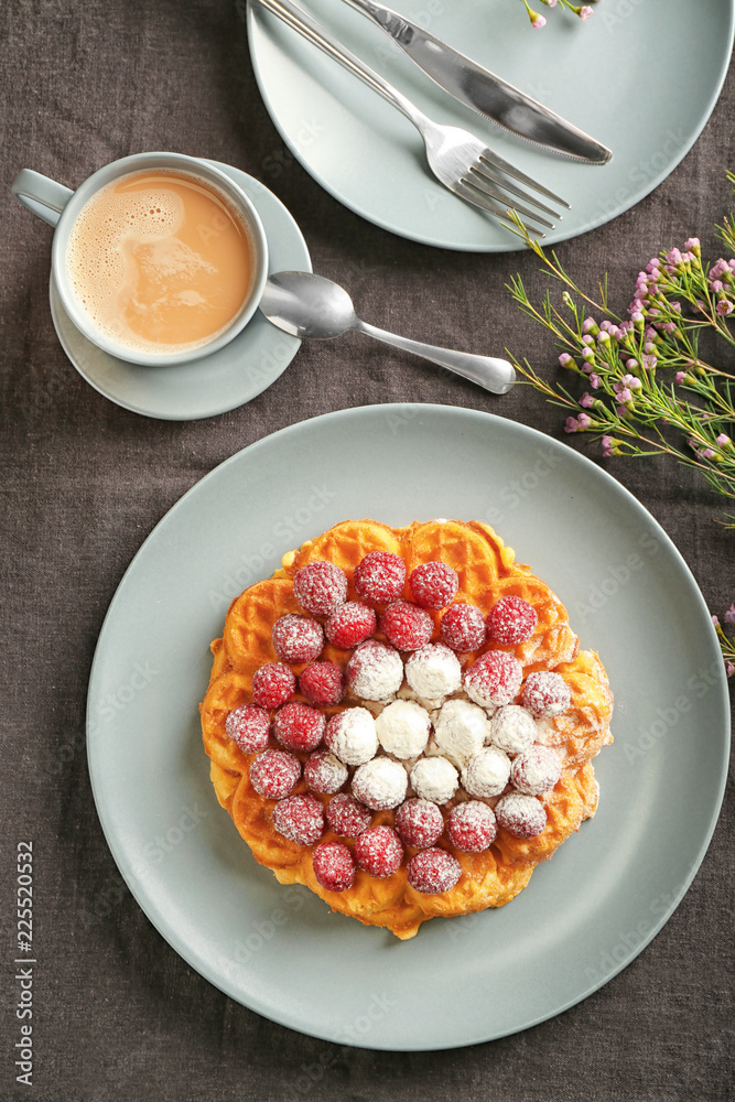 Plate with delicious waffles and cup of cocoa drink on table, top view