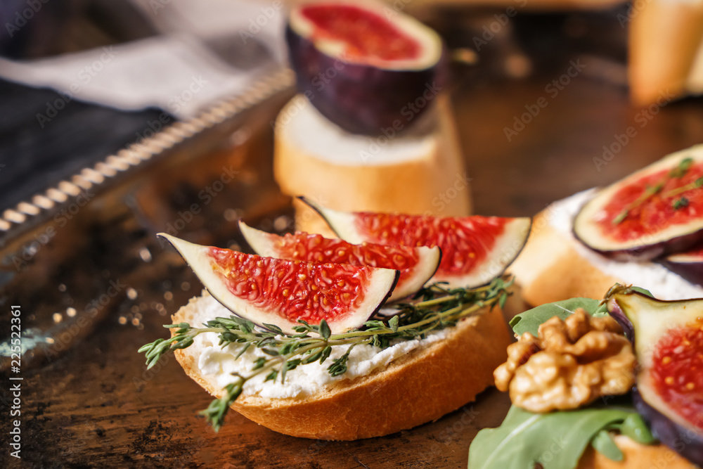 Tasty sandwiches with ripe fig on metal tray, closeup