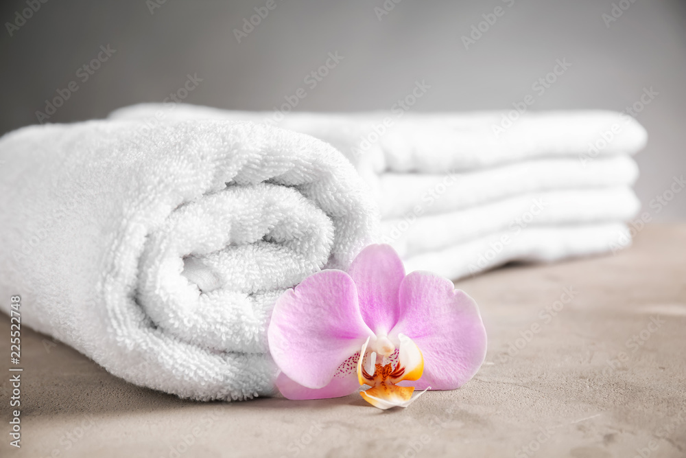 Rolled clean towel on table, closeup