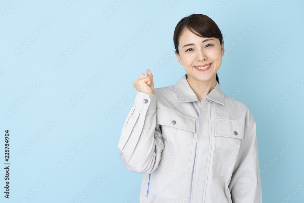 portrait of asian engineer woman on blue background