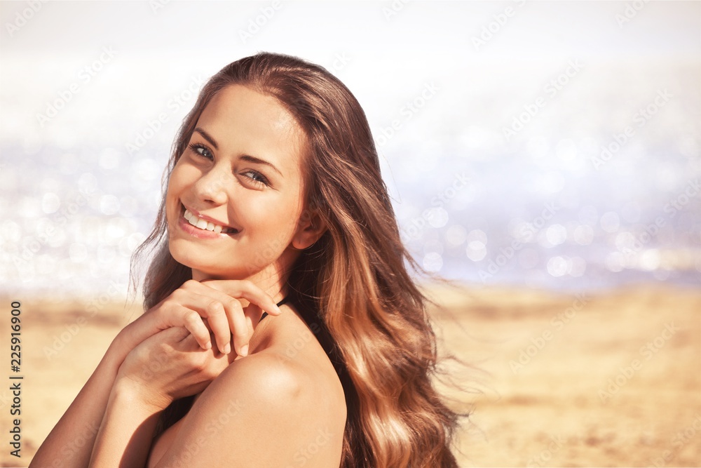 Young relaxed woman on blurred nature background