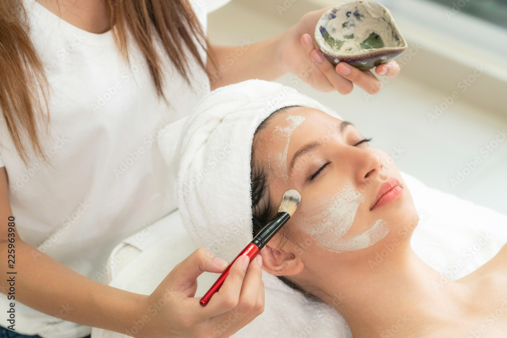 Beautiful woman having a facial treatment at spa.