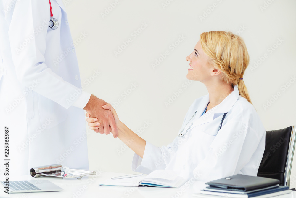 Doctor at hospital shakes hand with another doctor