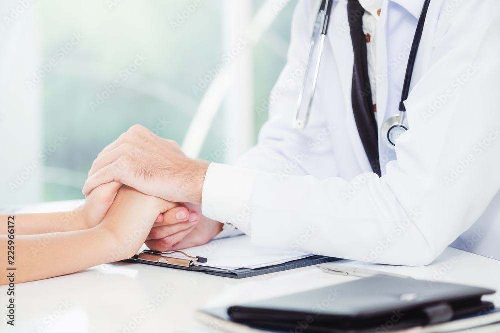 Male Doctor and Female Patient in Hospital Office