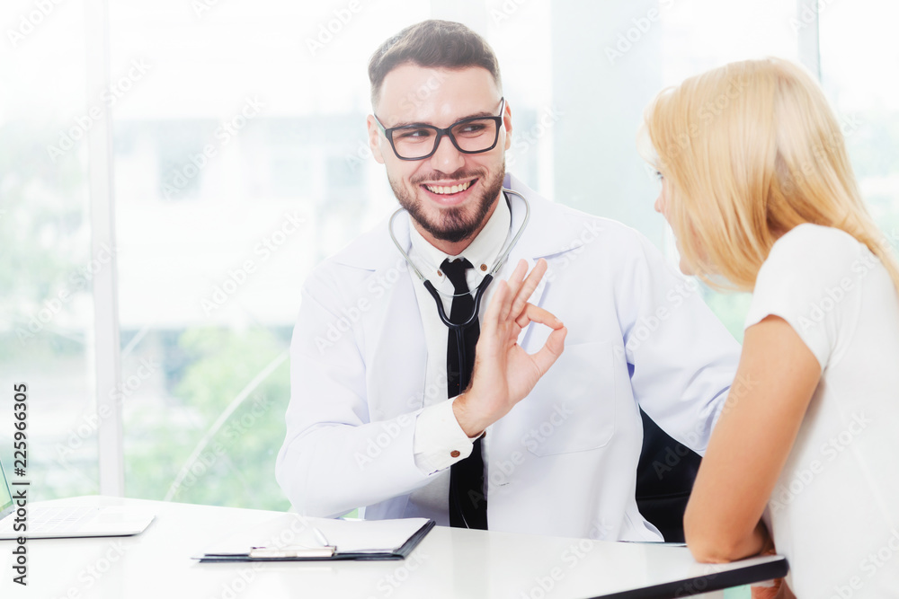 Male Doctor and Female Patient in Hospital Office