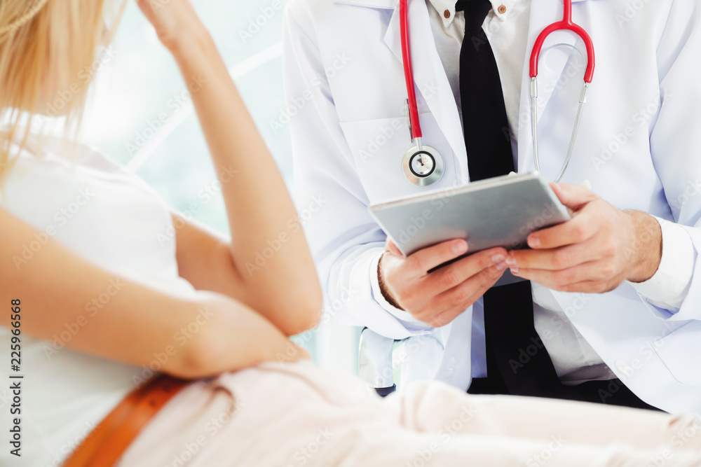 Male Doctor and Female Patient in Hospital Office