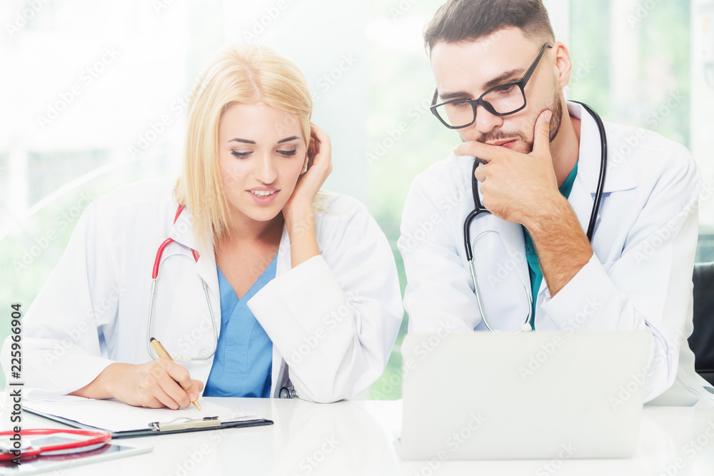 Two doctors partner works at office in hospital.