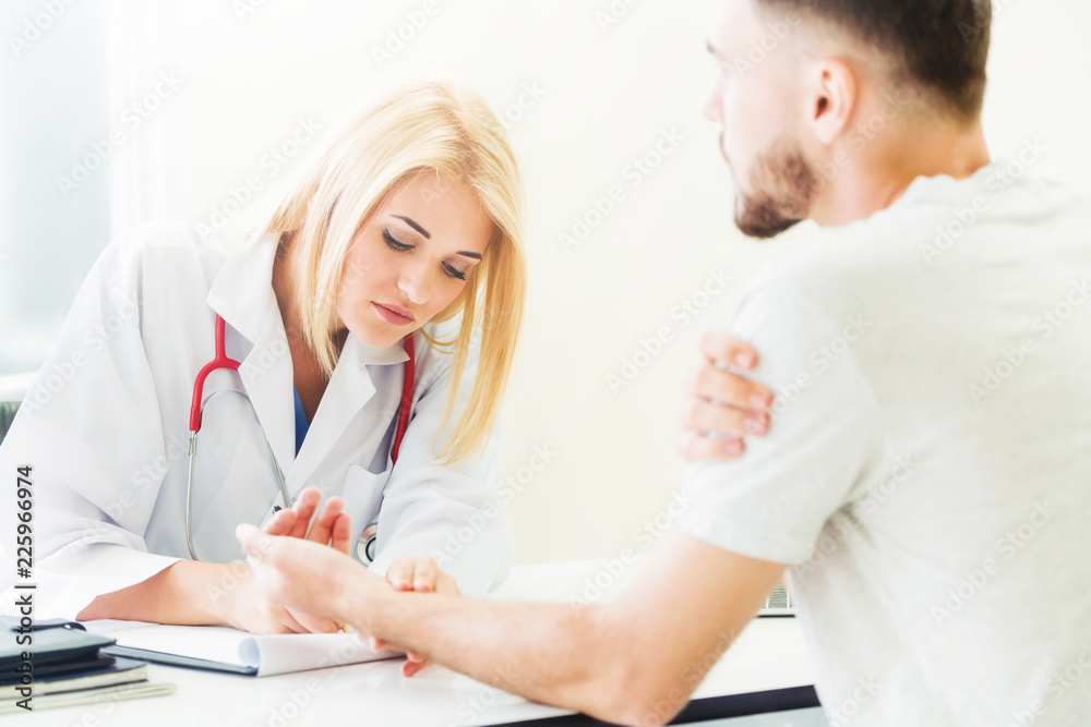 Woman Doctor and Male Patient in Hospital Office