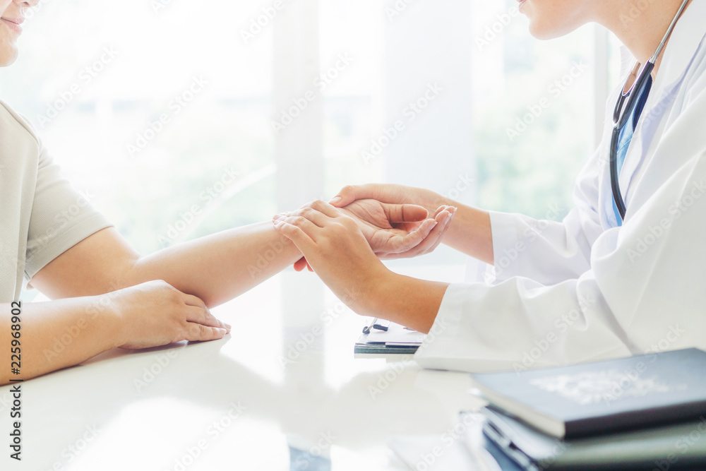 Woman Doctor and Female Patient in Hospital Office