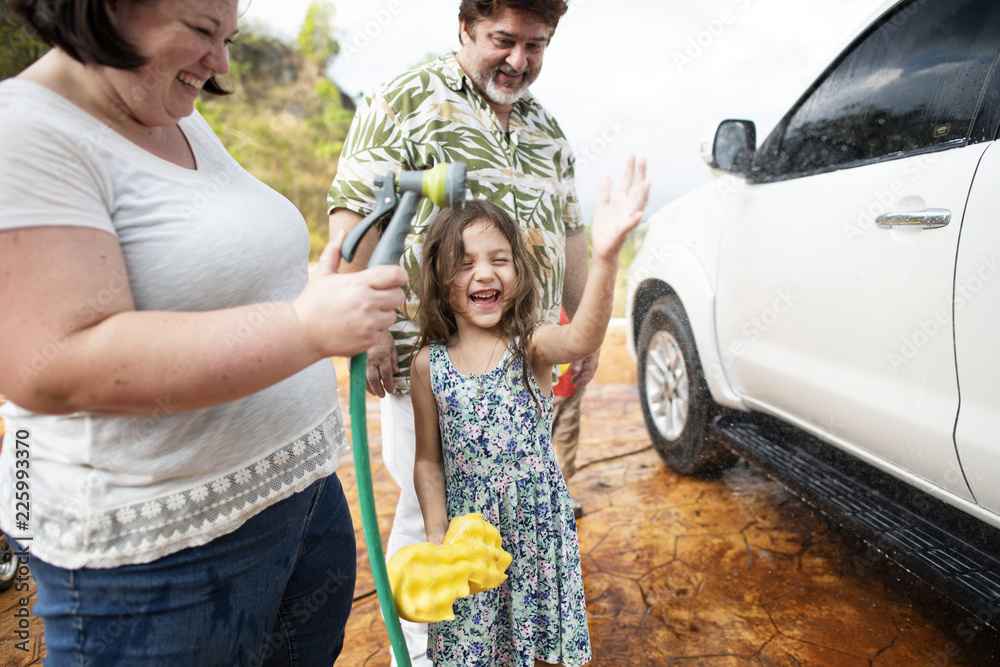 Family washing their white car