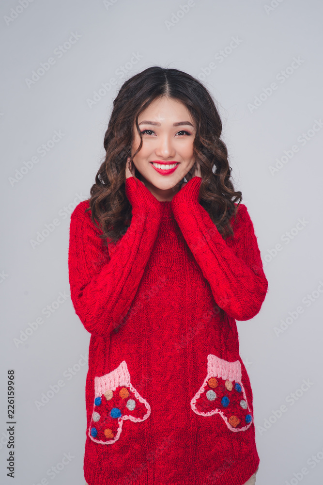 Beautiful smiling fashion model face with red lips in warm clothing