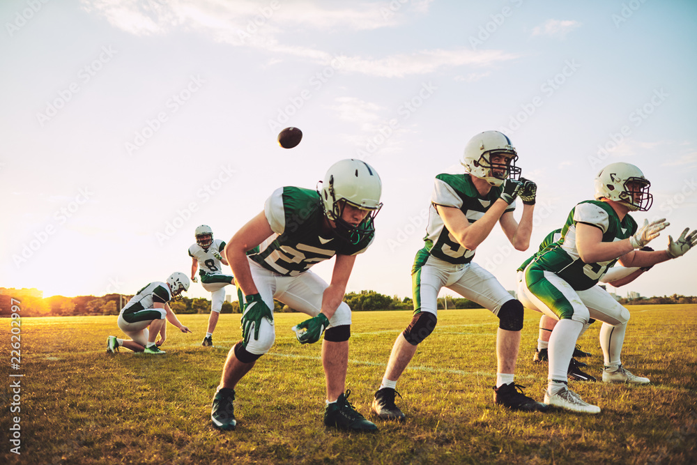 American football team practicing place kicking during practice